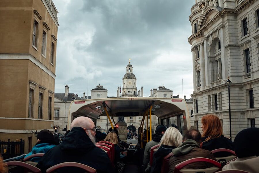 Open-top double-decker bus full of tourists in central London