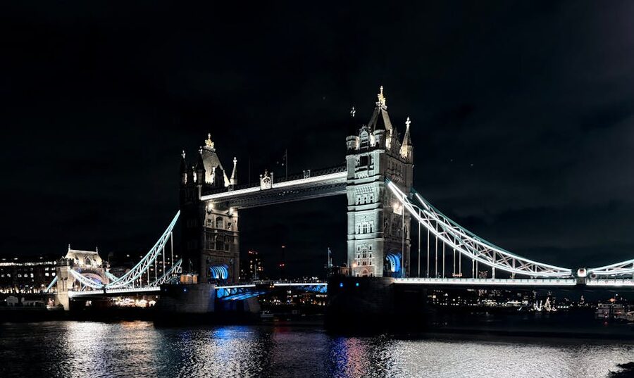 Tower Bridge illuminated gold against the night sky in London