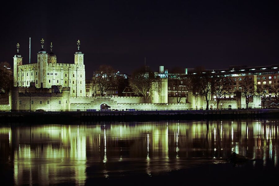Tower of London illuminated at night with the Thames