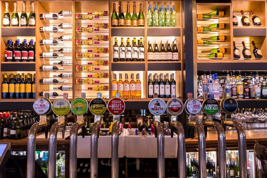 London pub bar with taps pouring a draught