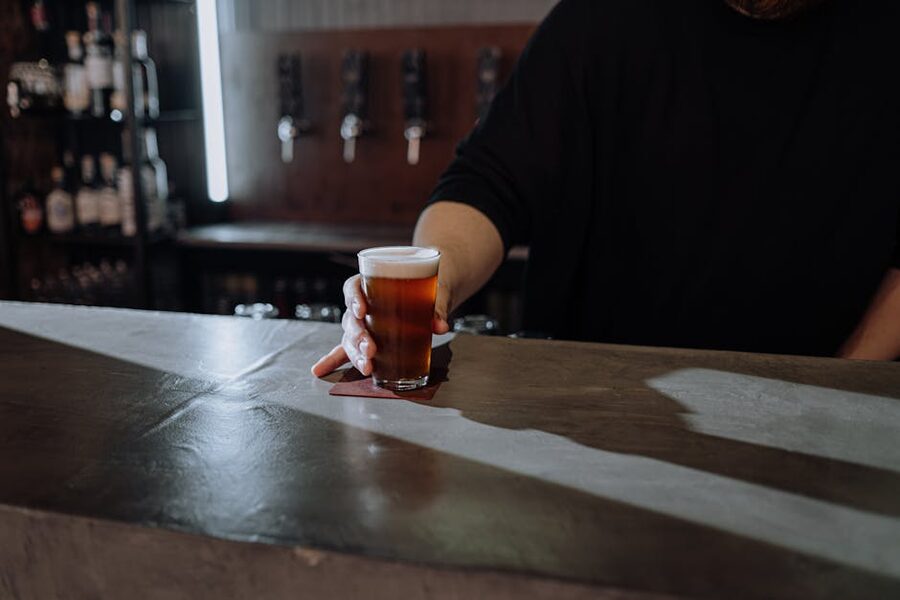 Bartender pours a craft beer in a London pub