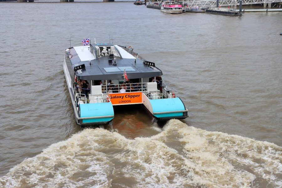 Galaxy Clipper Thames ferry passengers cityscape