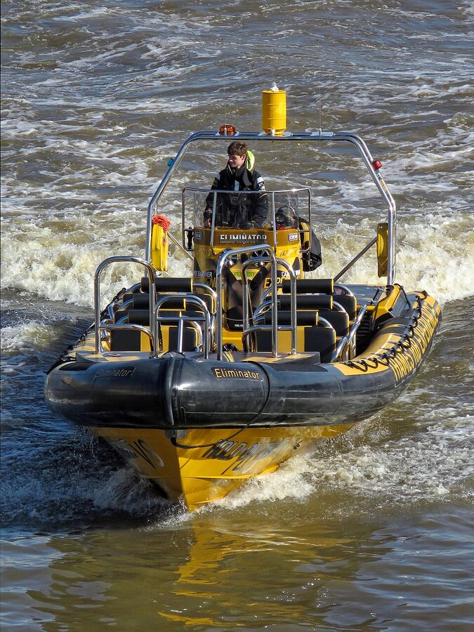 RIB speedboat passing under Tower Bridge on the River Thames