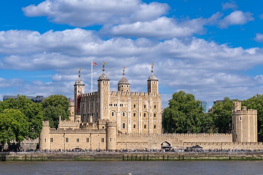 The Tower of London beside the Thames on a sunny day