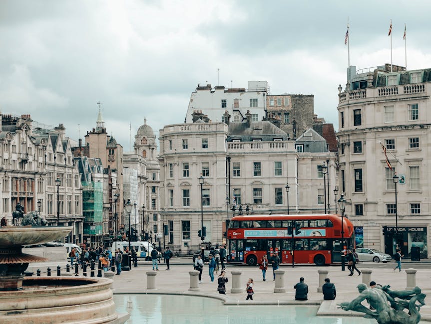 London double-decker passing Trafalgar Square fountain