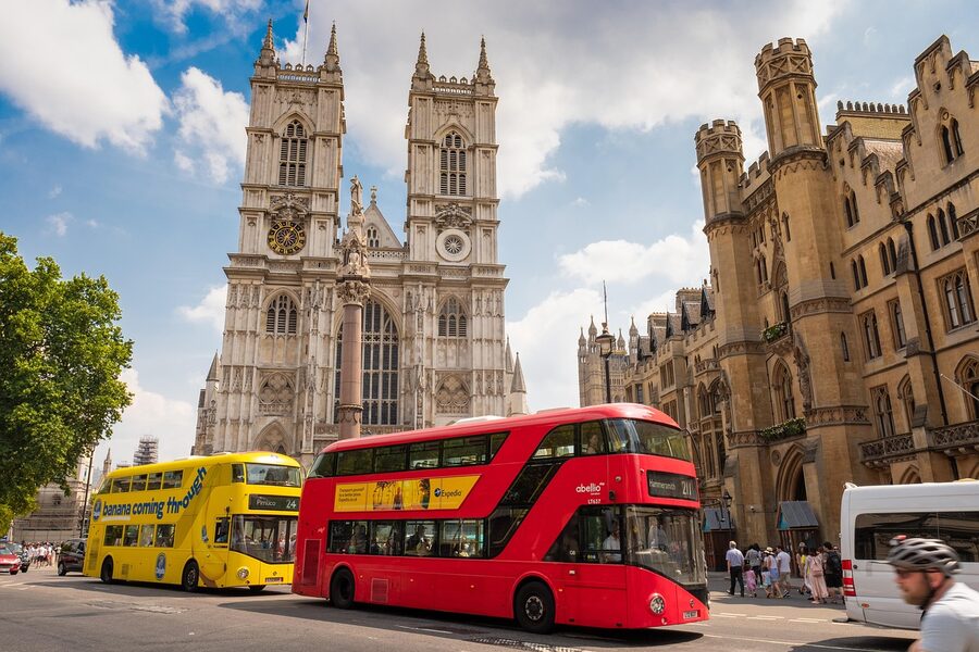 London bus passing Westminster Abbey on the road