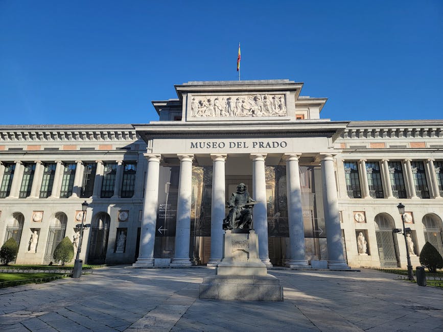 Prado Museum facade under blue skies in Madrid