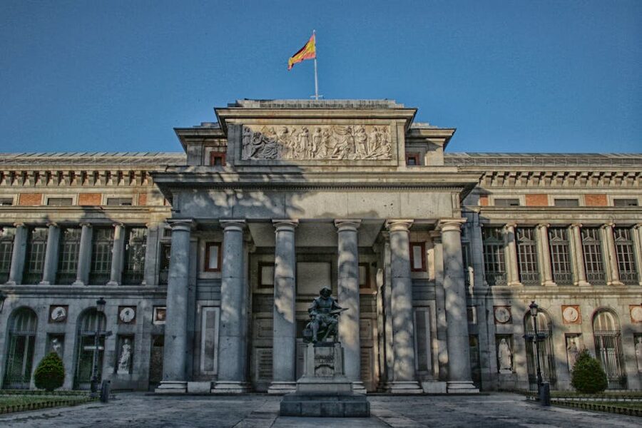 Prado Museum exterior with statue and clear sky in Madrid