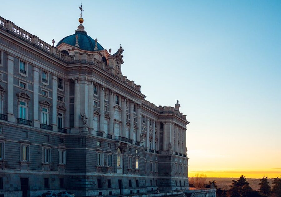 Royal Palace of Madrid lit by golden sunset light