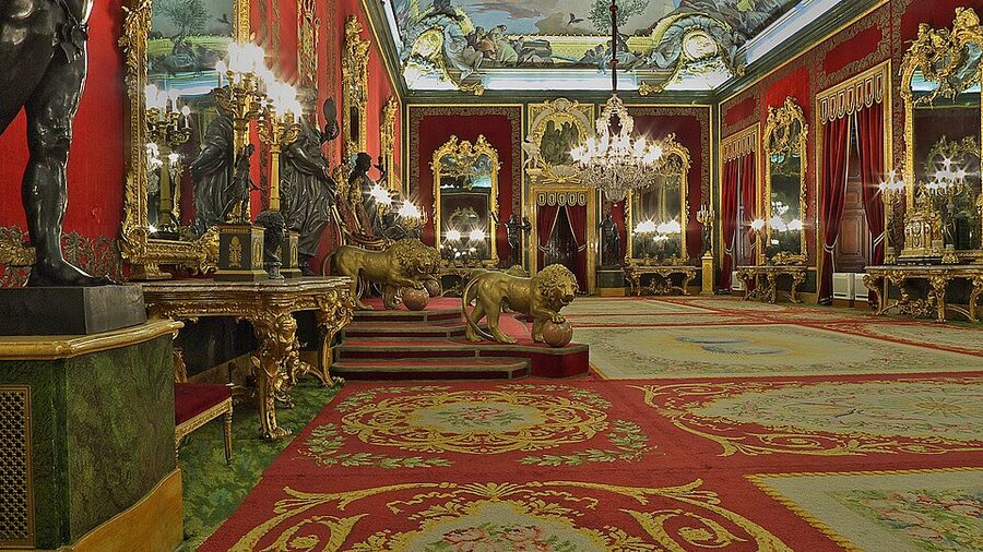 Throne Room of the Royal Palace of Madrid with red walls and gilded ornament