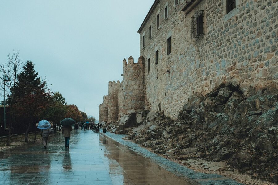 Avila rainy day walk by ancient walls Spain