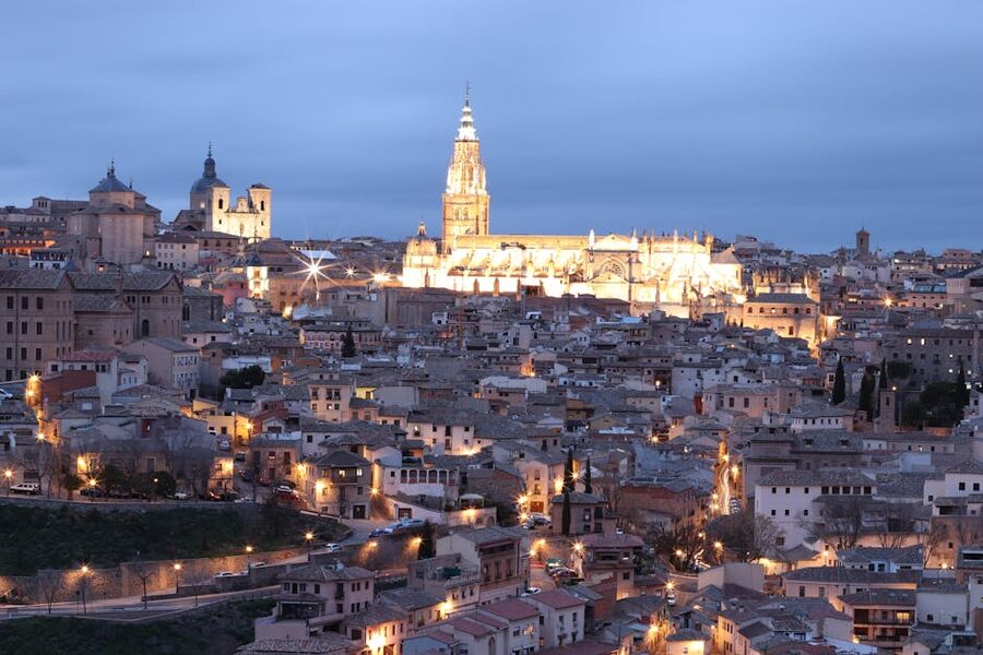 Toledo Cathedral illuminated at twilight with Gothic facade lit up