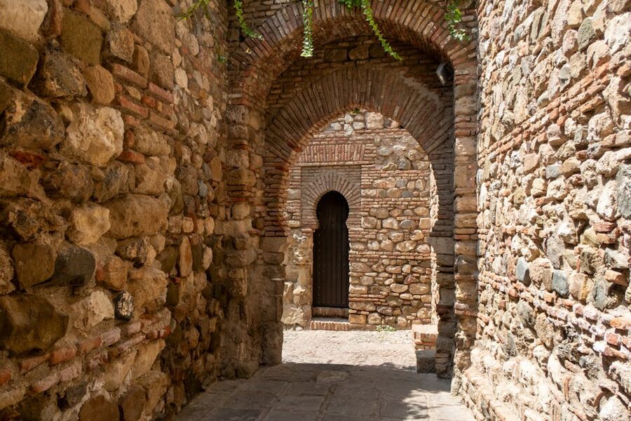 Sunlit stone arch passage in the Alcazaba Malaga