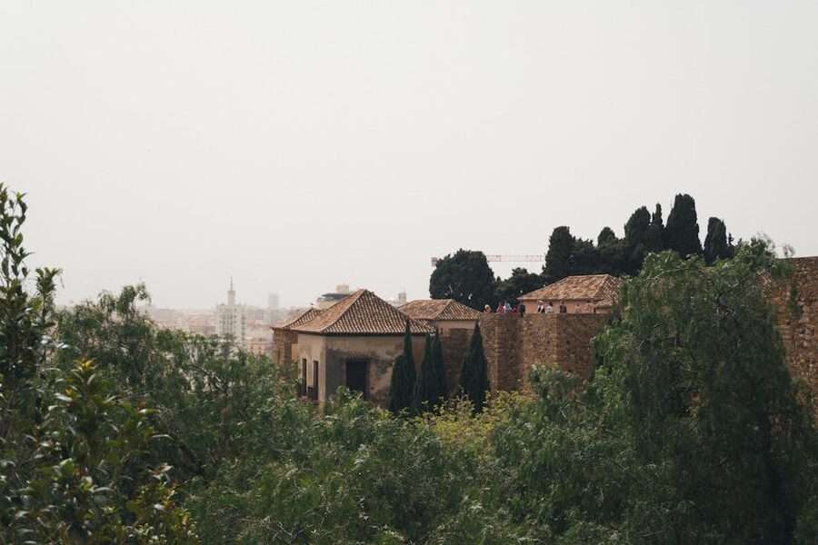 Alcazaba stone walls and Malaga rooftops