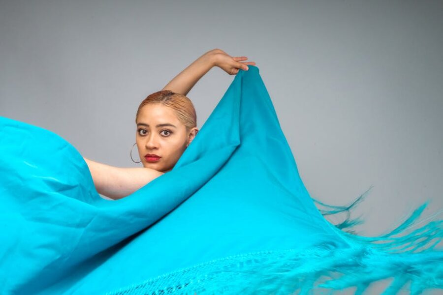 Flamenco dancer with blue fabric in graceful pose