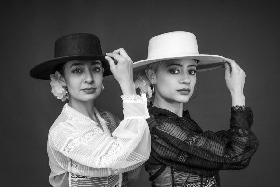 Two flamenco dancers in traditional hats