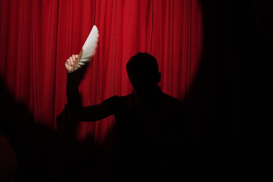 Flamenco silhouette on red stage