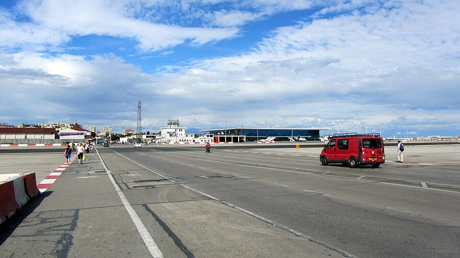 Pedestrians walking across the active runway at Gibraltar International Airport