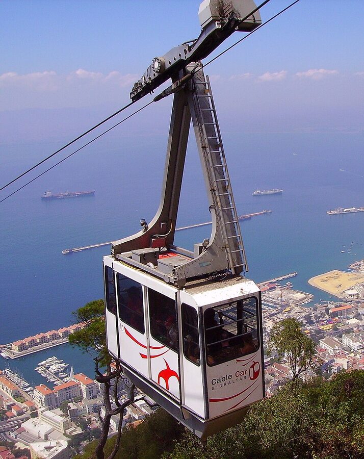 Gibraltar cable car heading up the Rock with the bay below
