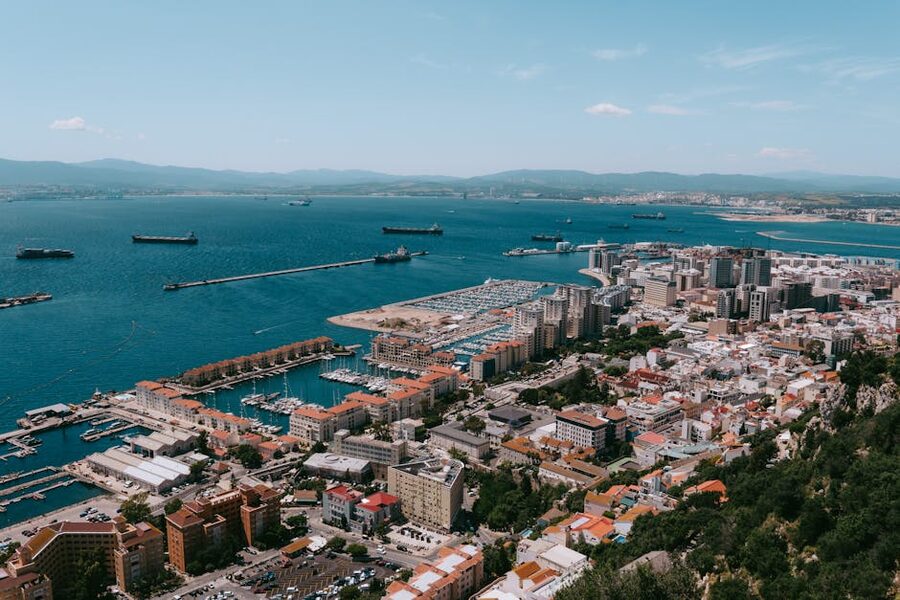 Aerial view of Gibraltar city, harbour, and runway from above