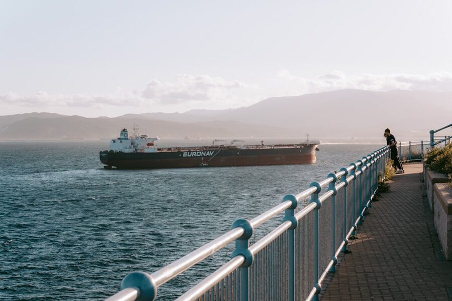 Cargo ship navigating the Strait of Gibraltar at sunset