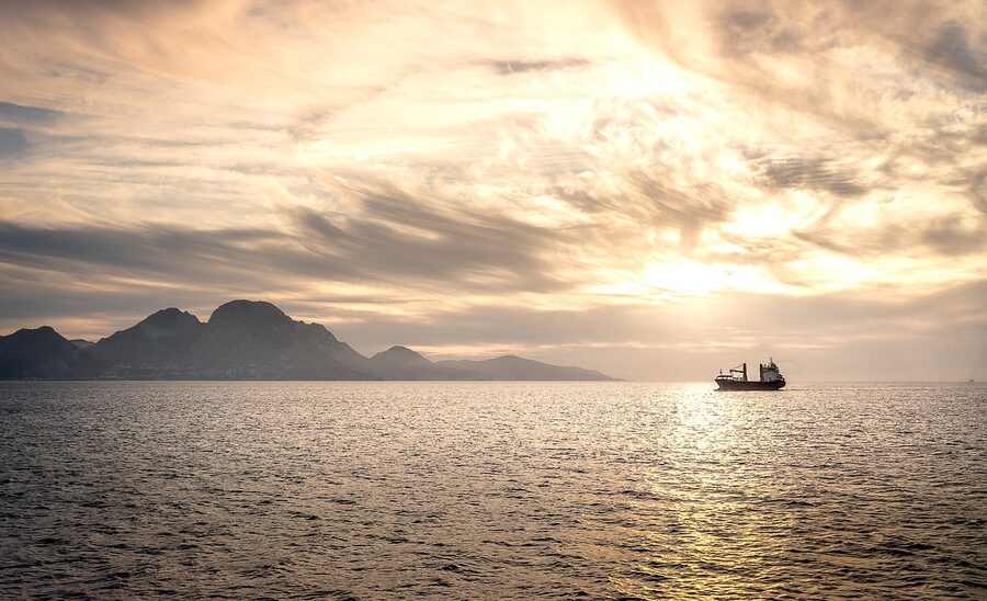 The Strait of Gibraltar at sunset with a yacht in the foreground