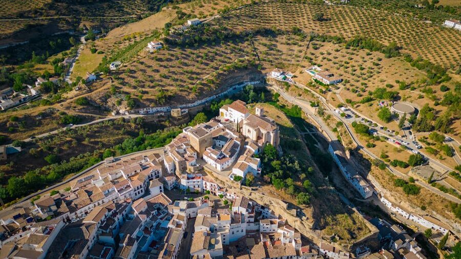 Aerial cinematic view of Setenil de las Bodegas Spain showing the unique rock-overhang town