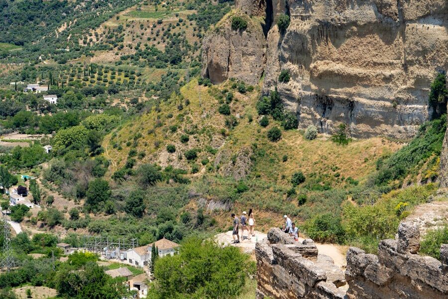 Tourists at the cliff viewpoint in Ronda Spain looking out over the valley