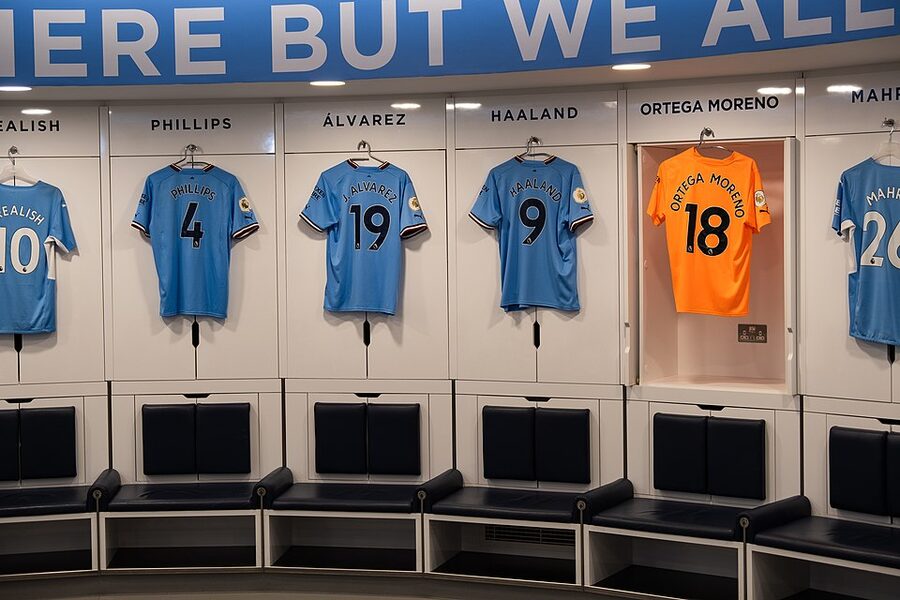 Manchester City home dressing room with kits