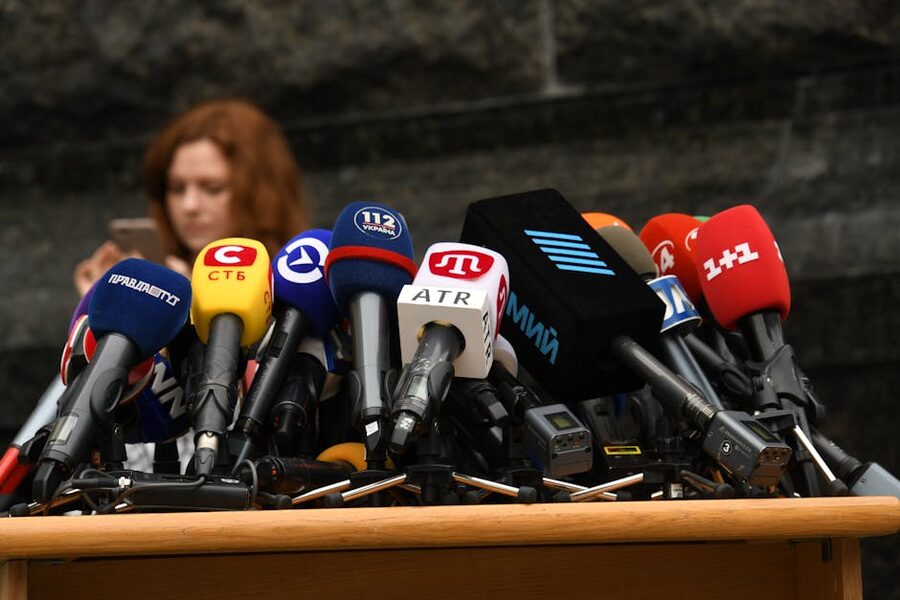 Press conference microphones set up at a podium