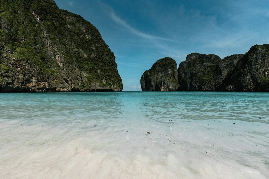 Beautiful white sand beach at Maya Bay with clear water and dramatic cliff backdrop