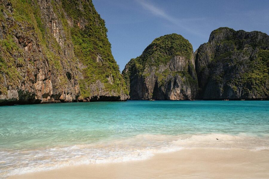 The famous Maya Bay beach with crystal clear turquoise water surrounded by limestone cliffs