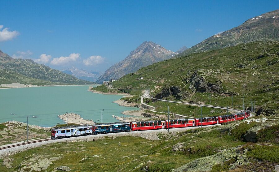 Bernina Express train at Lago Bianco summit Switzerland