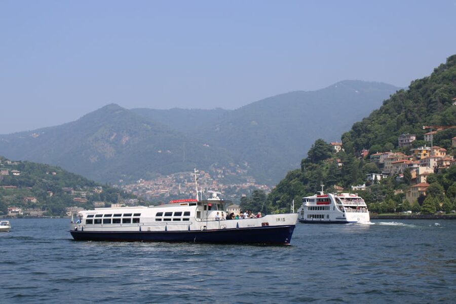 Passenger ferries on Lake Como with hills backdrop Lombardy