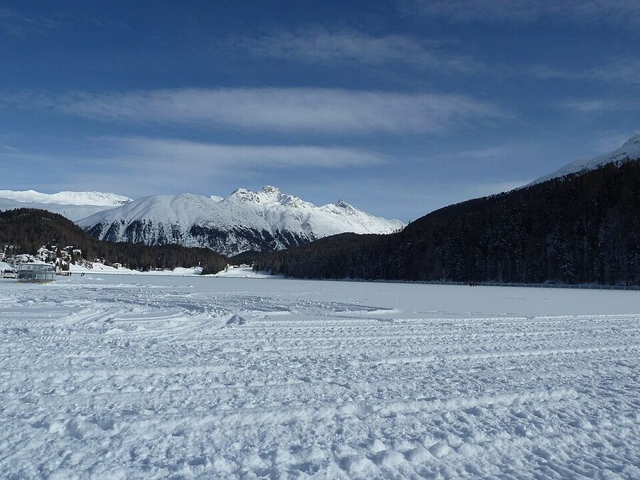 Lake St Moritz frozen in winter with snowy mountains