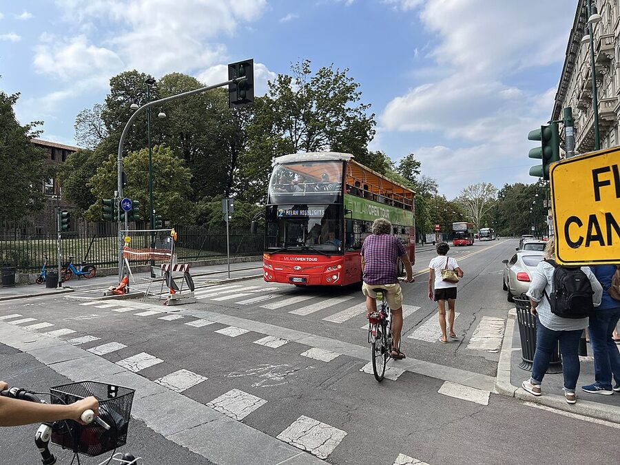 Milan Open Tour hop-on hop-off bus in Piazza Castello with Sforza Castle behind