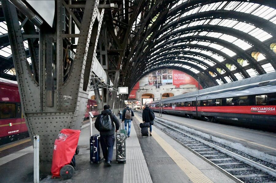 Travelers walking through Milan Central Station