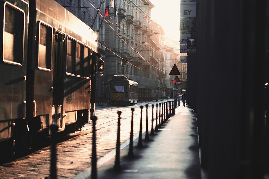Yellow Milan tram at a city intersection
