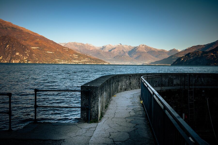 Bellagio stone quay on Lake Como with mountains in background