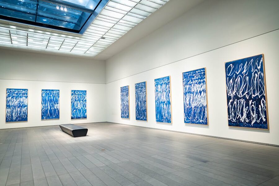 Modern art gallery with blue abstract paintings