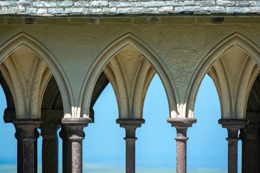 Stone arches and columns inside Mont Saint Michel Abbey