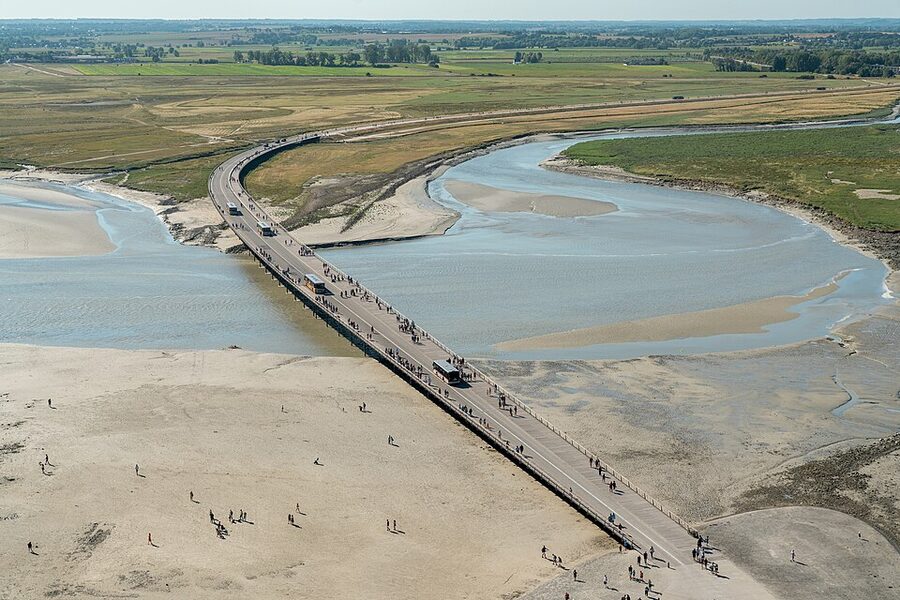 Bridge to Mont Saint Michel with shuttle bus crossing the causeway