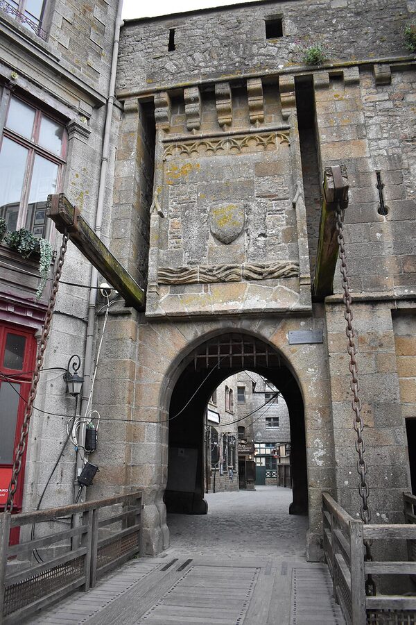 Narrow stone street climbing up through Mont Saint Michel village