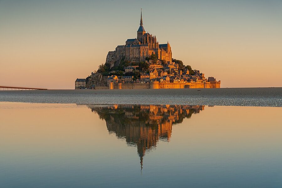 Sunrise at Mont Saint Michel with golden light on the abbey