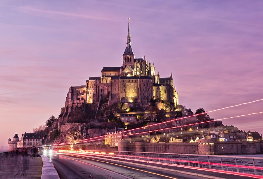 Mont Saint Michel at sunset showing the bay and abbey architecture