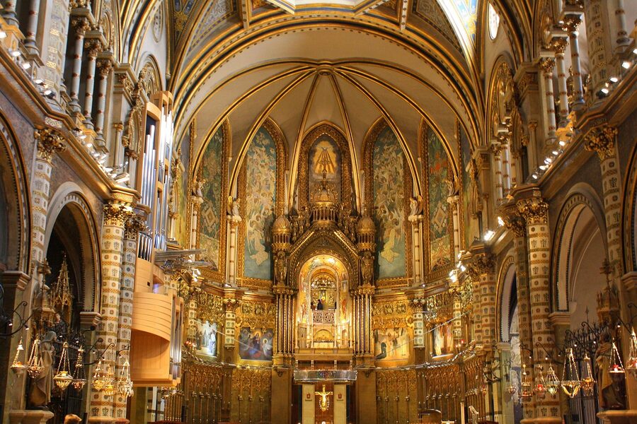 Montserrat basilica interior nave with chandeliers and gilt details