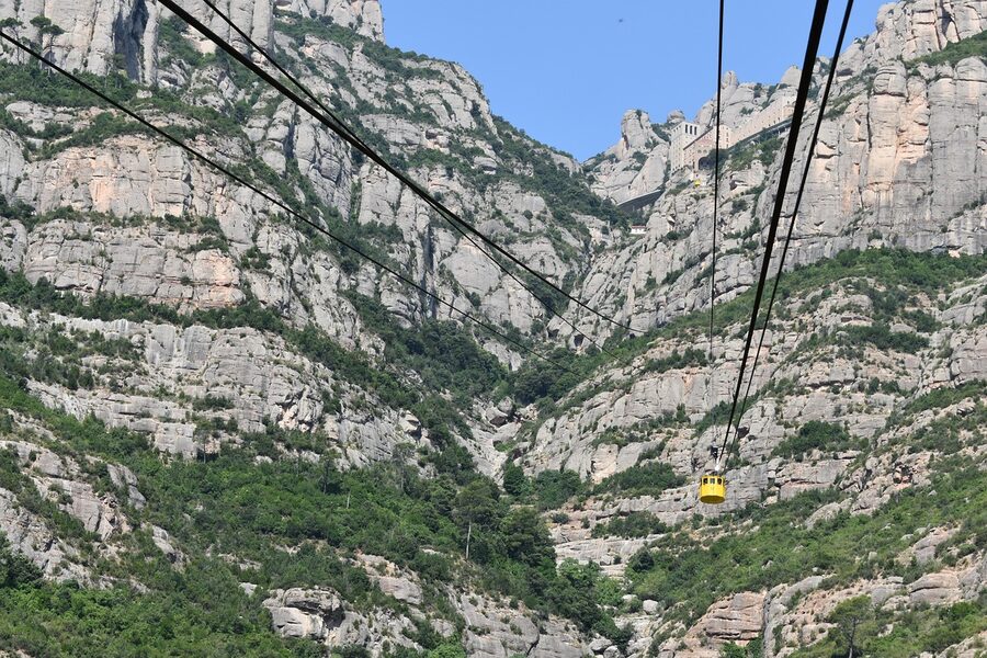 Aeri cable car cabin against the Montserrat cliff face