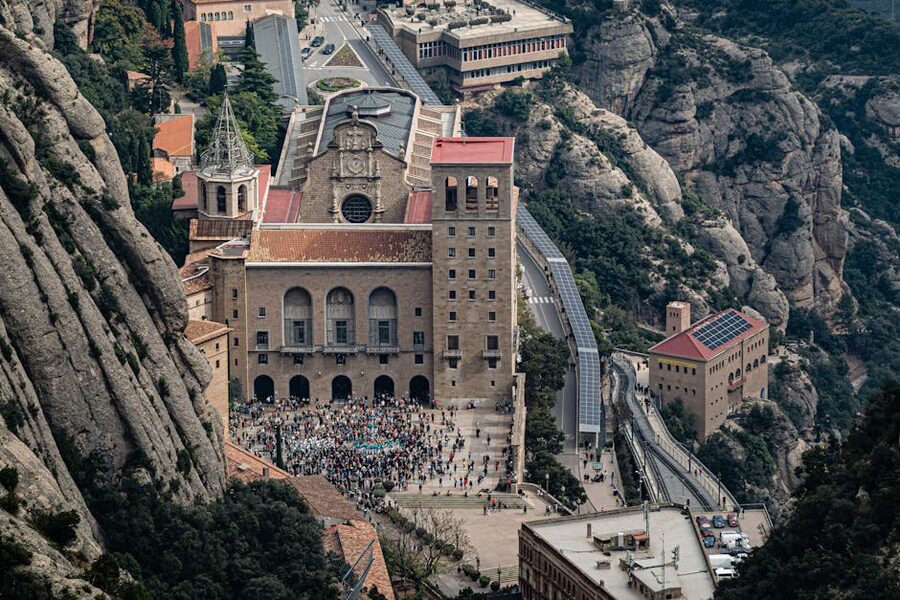 Aerial view of Santa Maria de Montserrat Abbey set among rocky mountains in Catalonia