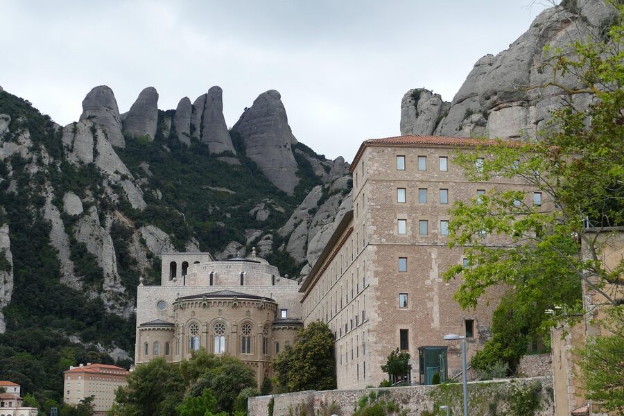 Montserrat monastery facade and stone buildings under blue sky