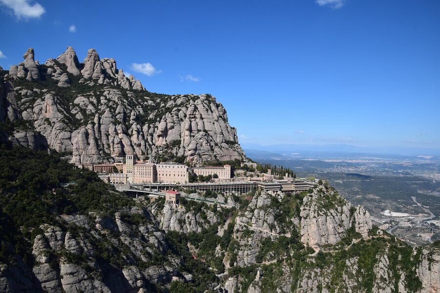 Montserrat monastery seen from a distance with mountain backdrop